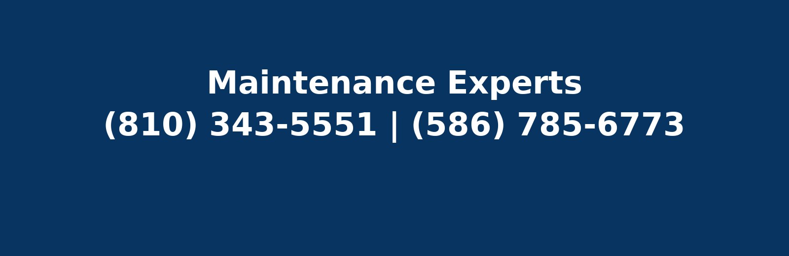 Technician flushing a downspout during gutter maintenance near Somerset Collection in Troy MI